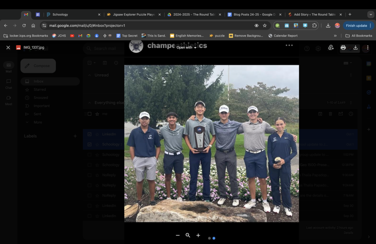 The golf team holds their trophy after winning the regional championship. Regionals were held at the South Riding golf course on Oct.1. 